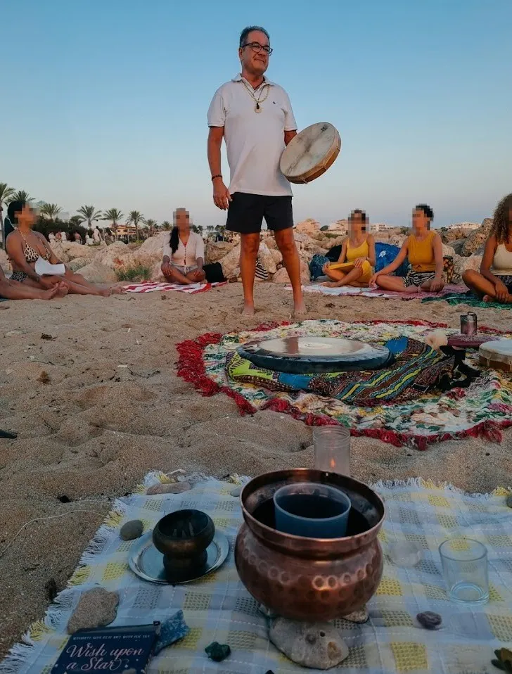 Xisco y participantes en un encuentro de sonido y meditación en la playa